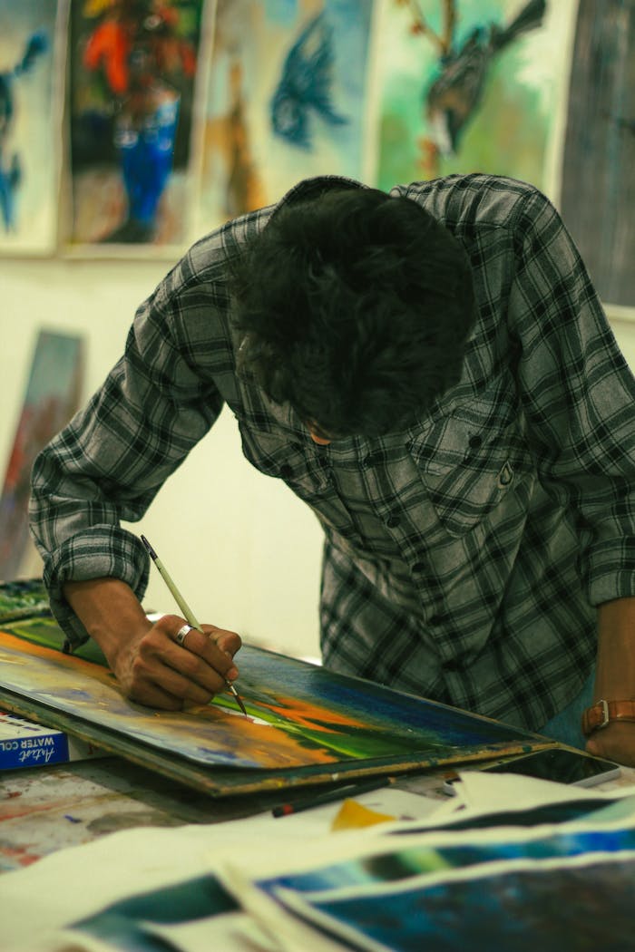 A talented artist engrossed in painting at a faculty of fine art in Dhaka, Bangladesh.